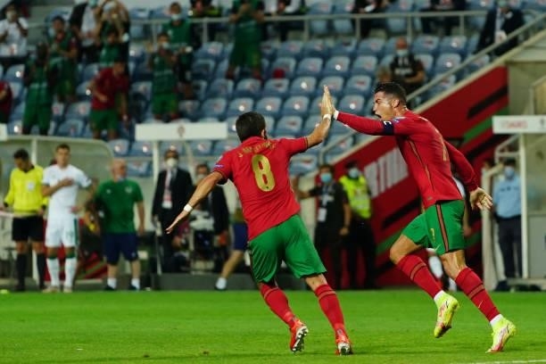 Cristiano Ronaldo of Manchester United and Portugal celebrates with teammate Joao Moutinho of Wolverhampton Wanderers and Portugal after scoring a...