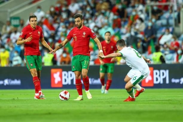 Bruno Fernandes of Manchester United and Portugal tries to escape Josh Cullen of Republic of Ireland and Anderlecht during the 2022 FIFA World Cup...
