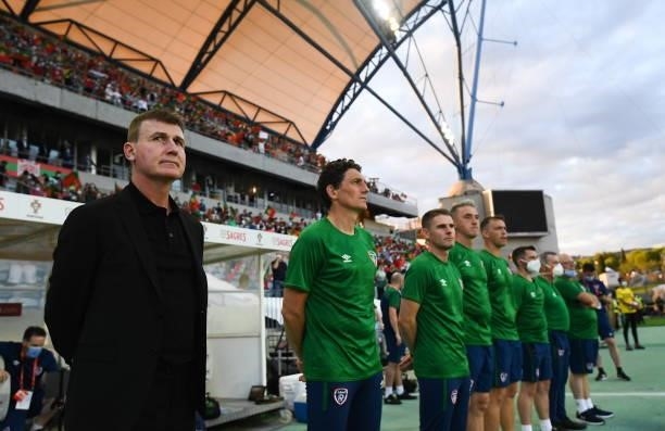 Faro , Portugal - 1 September 2021; Republic of Ireland manager Stephen Kenny, left, stands with his backroom staff for the national anthem before...