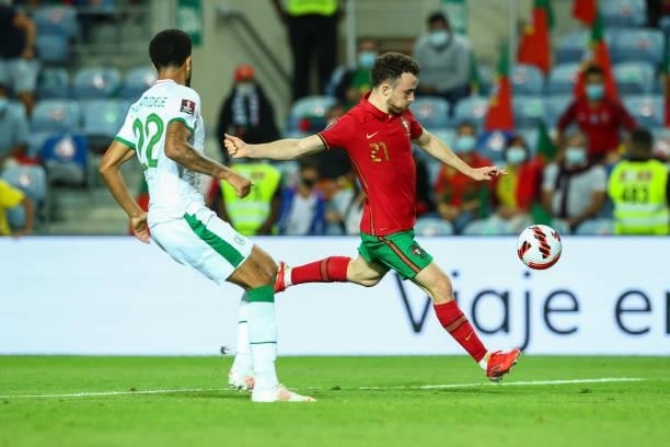 Diogo Jota of Liverpool FC and Portugal tries to escape Andrew Omobamidele of Republic of Ireland and Norwich City during the 2022 FIFA World Cup...
