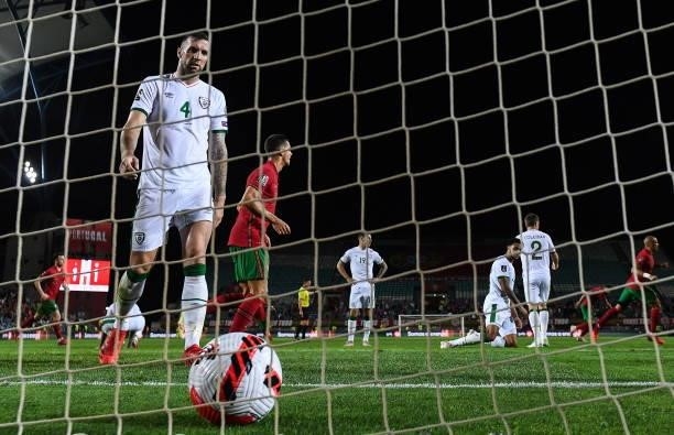 Faro , Portugal - 1 September 2021; Shane Duffy of Republic of Ireland makes his way to retrieve the ball after conceding their second goal, scored...
