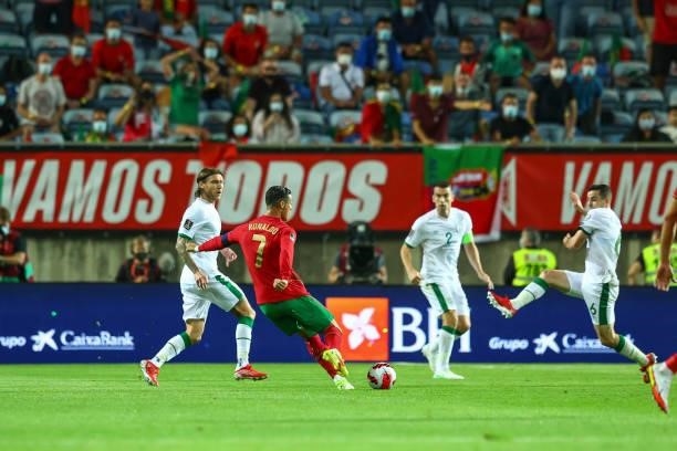 Cristiano Ronaldo of Manchester United and Portugal tries to escape Ireland defenders during the 2022 FIFA World Cup Qualifier match between Portugal...
