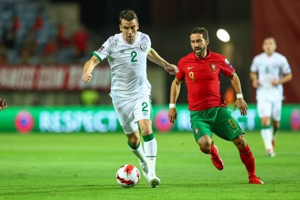 Seamus Coleman of Republic of Ireland and Everton tries to escape Joao Moutinho of Wolverhampton Wanderers and Portugal during the 2022 FIFA World...