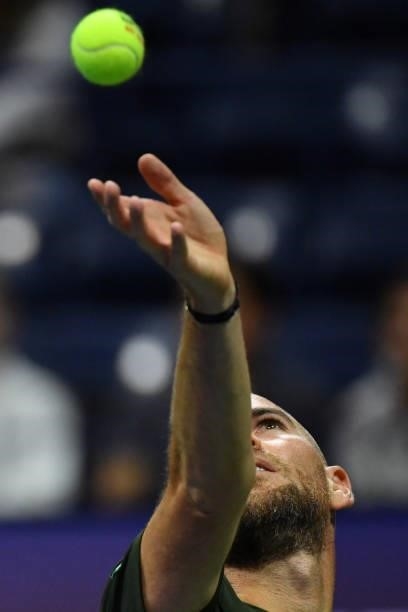France's Adrian Mannarino serves to Greece's Stefanos Tsitsipas during their 2021 US Open Tennis tournament men's singles second round match at the...