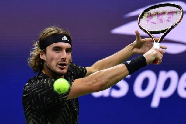 Greece's Stefanos Tsitsipas hits a return to France's Adrian Mannarino during their 2021 US Open Tennis tournament men's singles second round match...