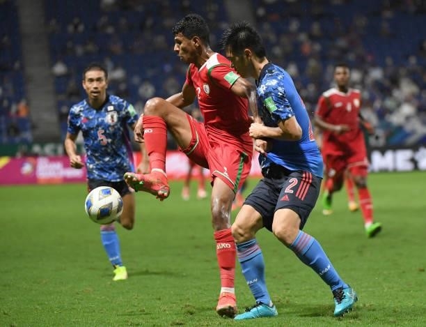 Issam Abdallah Al Sabhi of Oman keeps the ball under the pressure from Naomichi Ueda of Japan during FIFA World Cup Asian Qualifier Final Round Group...