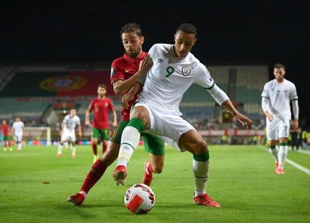 Faro , Portugal - 1 September 2021; Adam Idah of Republic of Ireland in action against Bernardo Silva of Portugal during the FIFA World Cup 2022...