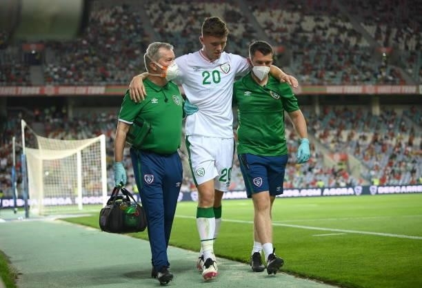 Faro , Portugal - 1 September 2021; Dara O'Shea of Republic of Ireland leaves the pitch after picking up an injury assisted by Republic of Ireland...