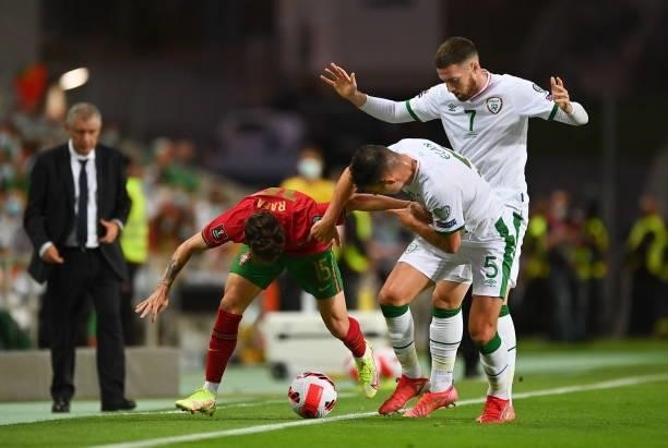 Faro , Portugal - 1 September 2021; Rafa of Portugal in action against John Egan and Matt Doherty of Republic of Ireland during the FIFA World Cup...