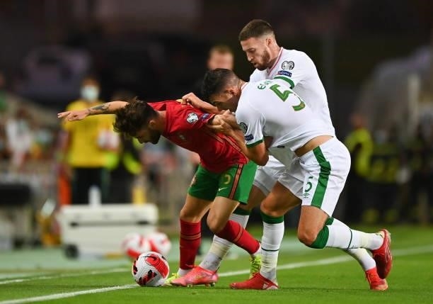 Faro , Portugal - 1 September 2021; Rafa of Portugal in action against John Egan and Matt Doherty of Republic of Ireland during the FIFA World Cup...