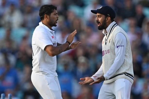 India's Umesh Yadav celebrates with India's KL Rahul after bowling England's captain Joe Root for 21 runs during play on the first day of the fourth...