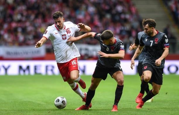 Jakub Moder of Poland competes with Berat Djimsiti of Albania during the 2022 FIFA World Cup Qualifier match between Poland and Albania at National...