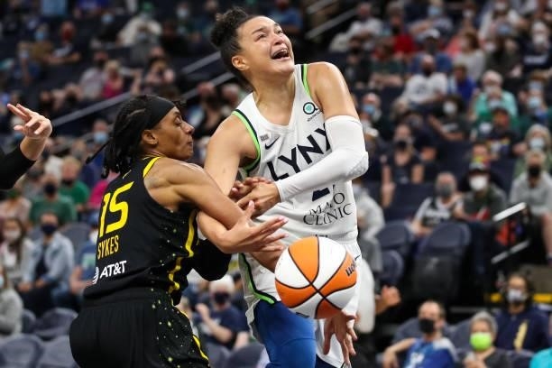 Kayla McBride of the Minnesota Lynx is fouled by Brittney Sykes of the Los Angeles Sparks in the second half of the game at Target Center on...