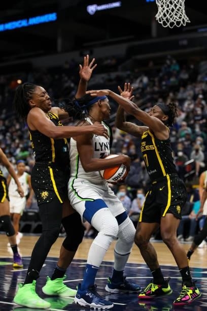 Sylvia Fowles of the Minnesota Lynx handles the ball while Erica Wheeler and Nneka Ogwumike of the Los Angeles Sparks defend in the second half of...