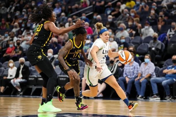 Rachel Banham of the Minnesota Lynx drives to the basket while Erica Wheeler and Nneka Ogwumike of the Los Angeles Sparks defend in the second half...