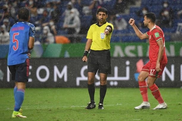 Ali Sulaiman Al Busaidi of Oman reacts as referee Mohammed Abdulla Mohammed rules a penalty for a handball by Yuto Nagatomo of Japan during FIFA...