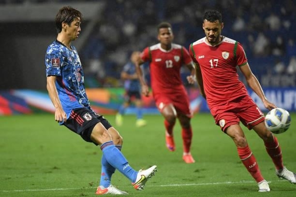 Yuya Osako of Japan passes the ball under the puressure from Ali Sulaiman Al Busaidi of Oman during FIFA World Cup Asian Qualifier Final Round Group...