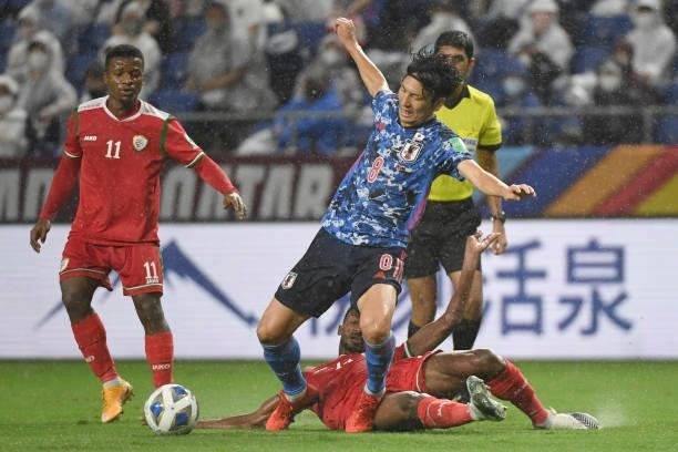 Genki Haraguchi of Japan fouled by Zahir Sulaiman Al Aghbari of Oman during FIFA World Cup Asian Qualifier Final Round Group B match between Japan...