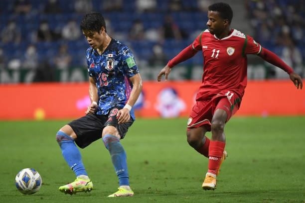 Hiroki Sakai of Japan keeps the ball under the pressure from Almandlhar Al Asawi of Oman during FIFA World Cup Asian Qualifier Final Round Group B...