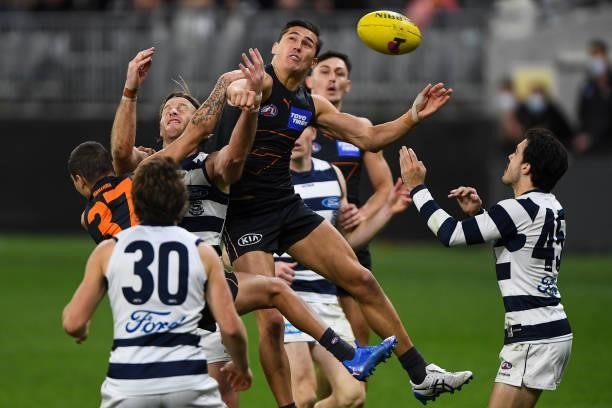 Isaac Cumming of the Giants spoils in a marking contest during the 2021 AFL Second Semi Final match between the Geelong Cats and the GWS Giants at...