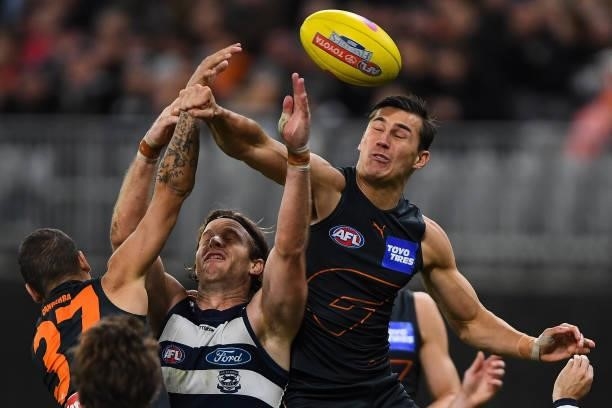 Isaac Cumming of the Giants spoils in a marking contest during the 2021 AFL Second Semi Final match between the Geelong Cats and the GWS Giants at...
