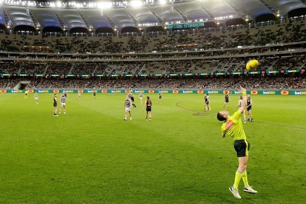 The boundary umpire throws the ball into play during the 2021 AFL Second Semi Final match between the Geelong Cats and the GWS Giants at Optus...