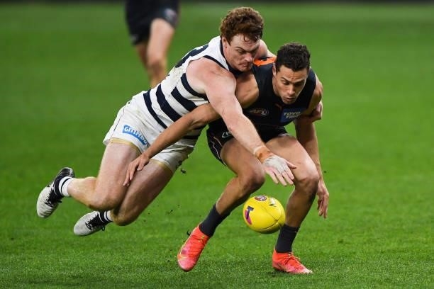 Josh Kelly of the Giants competes for the ball with Gary Rohan of the Cats during the 2021 AFL Second Semi Final match between the Geelong Cats and...