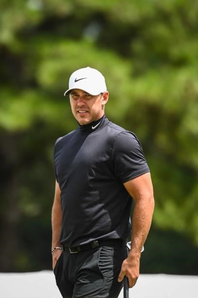 Brooks Koepka, wearing a Nike NOCTA turtleneck, walks on the third hole green during the first round of the TOUR Championship, the final event of the...
