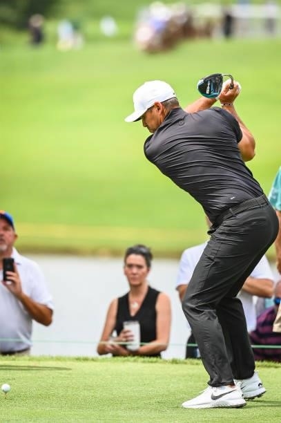 Brooks Koepka, wearing a Nike NOCTA turtleneck, at the top of his swing as he plays his shot from the fourth hole tee during the first round of the...