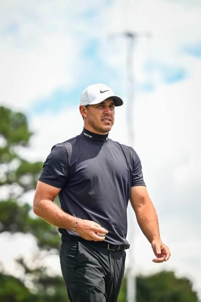 Brooks Koepka, wearing a Nike NOCTA turtleneck, walks off the third hole green during the first round of the TOUR Championship, the final event of...