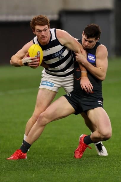 Gary Rohan of the Cats is tackled by Lachie Ash of the Giants during the 2021 AFL Second Semi Final match between the Geelong Cats and the GWS Giants...