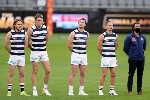 The players line up for the Australian National Anthem during the 2021 AFL Second Semi Final match between the Geelong Cats and the GWS Giants at...