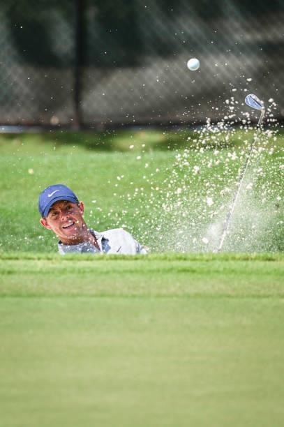 Rory McIlroy of Northern Ireland plays a shot from a greenside bunker on the 11th hole during the first round of the TOUR Championship, the final...