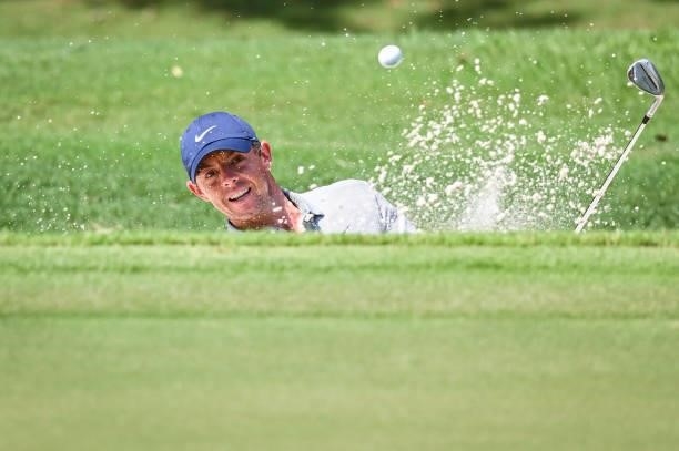 Rory McIlroy of Northern Ireland plays a shot from a greenside bunker on the 11th hole during the first round of the TOUR Championship, the final...