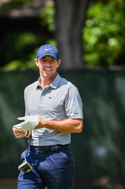 Rory McIlroy of Northern Ireland smiles after nearly holing out on the 11th hole during the first round of the TOUR Championship, the final event of...