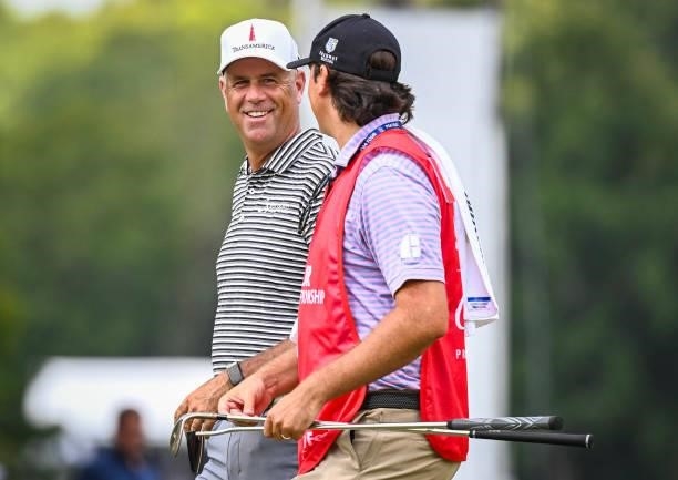 Stewart Cink smiles with his caddie and son Reagan on the second hole during the first round of the TOUR Championship, the final event of the...