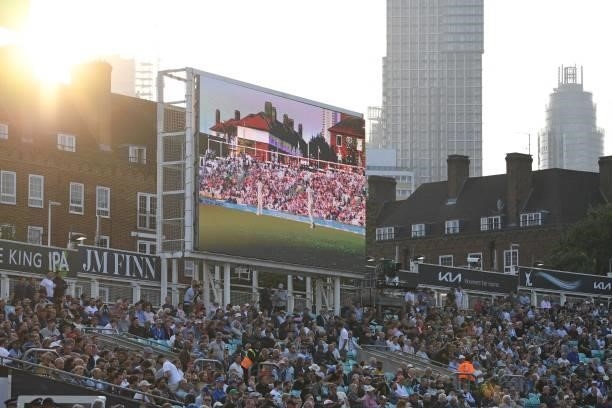 The big screen shows play as the sun sets behind surrounding buildings on the second day of the fourth cricket Test match between England and India...
