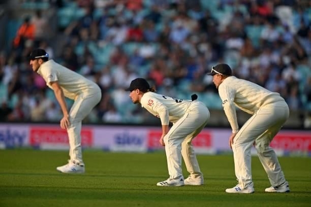 England's Craig Overton , England's Rory Burns and England's captain Joe Root in the field during play on the second day of the fourth cricket Test...