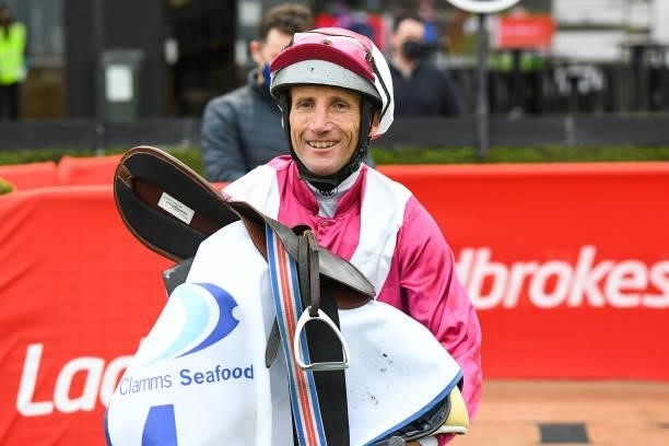 Damien Oliver returns to the mounting yard after winning the Clamms Seafood Feehan Stakes at Moonee Valley Racecourse on September 04, 2021 in Moonee...