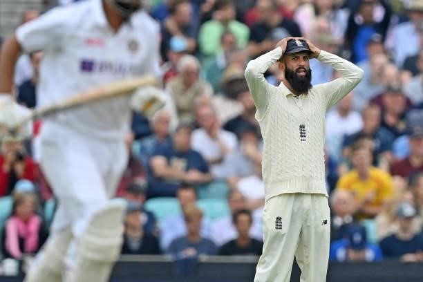 England's Moeen Ali reacts in the field during play on the third day of the fourth cricket Test match between England and India at the Oval cricket...