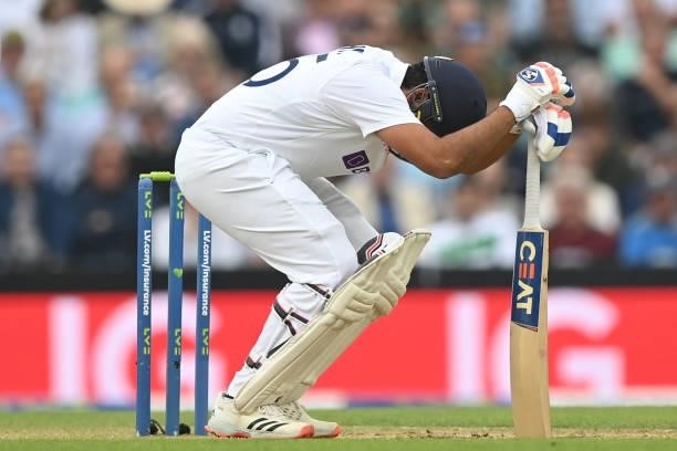 India's Rohit Sharma reacts after being hit by the ball during play on the third day of the fourth cricket Test match between England and India at...