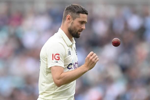 England's Chris Woakes prepares to bowl during play on the third day of the fourth cricket Test match between England and India at the Oval cricket...