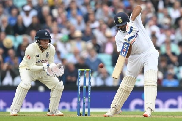 India's Rohit Sharma plays a shot as England's Jonny Bairstow keeps wicket during play on the third day of the fourth cricket Test match between...