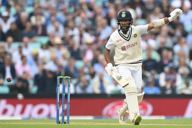 India's Cheteshwar Pujara gestures during play on the third day of the fourth cricket Test match between England and India at the Oval cricket ground...