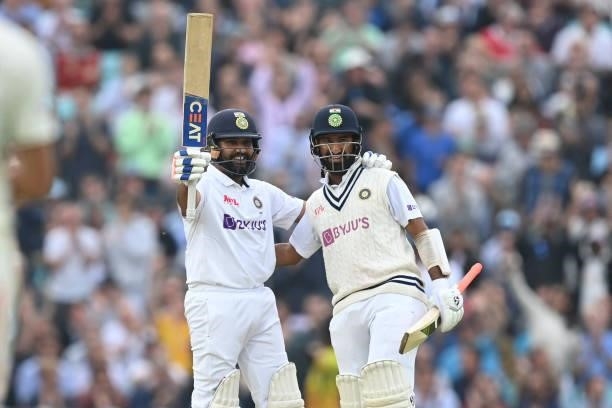 India's Rohit Sharma is congratulated by India's Cheteshwar Pujara after reaching his century during play on the third day of the fourth cricket Test...