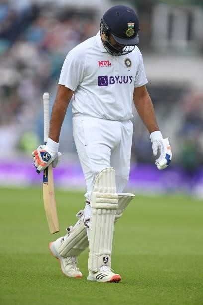 India's Rohit Sharma walks back to the pavilion after losing his wicket for 127 runs during play on the third day of the fourth cricket Test match...