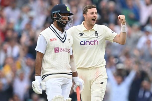 England's Ollie Robinson celebrates after taking the wicket of India's Rohit Sharma for 127 runs during play on the third day of the fourth cricket...