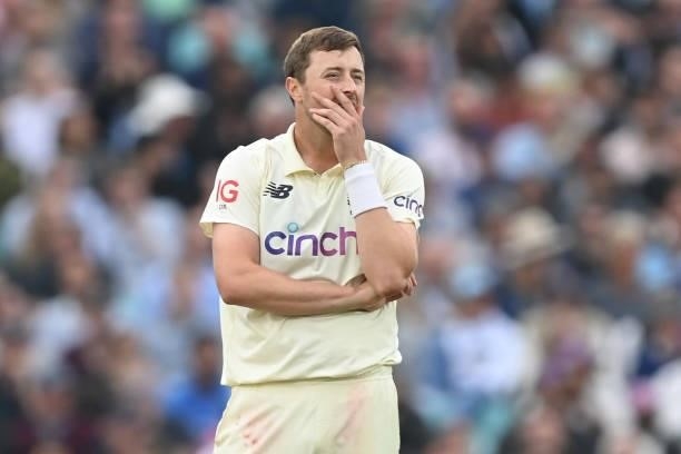 England's Ollie Robinson reacts while bowling during play on the third day of the fourth cricket Test match between England and India at the Oval...
