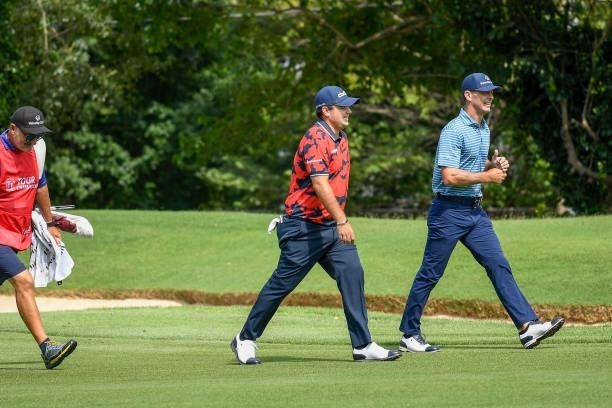 Patrick Reed and Billy Horschel walk up the first fairway during the first round of the TOUR Championship at East Lake Golf Club on September 2, 2021...
