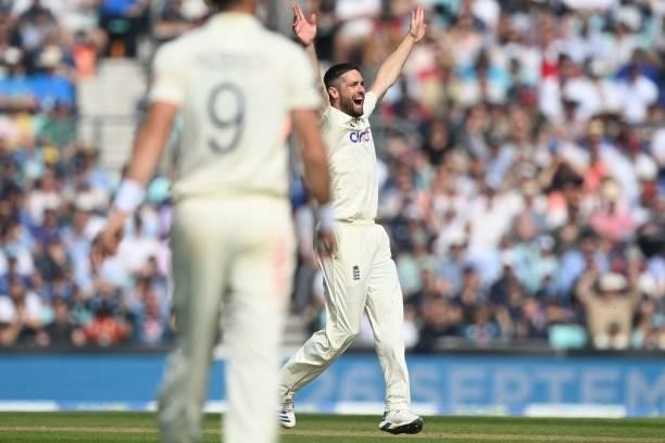 England's Chris Woakes celebrates after having India's Ajinkya Rahane trapped LBW without scoring during play on the fourth day of the fourth cricket...